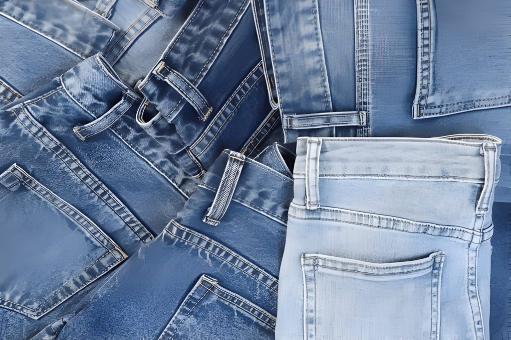 A stylish display of different types of jeans including skinny jeans, bootcut jeans, and relaxed fit jeans.